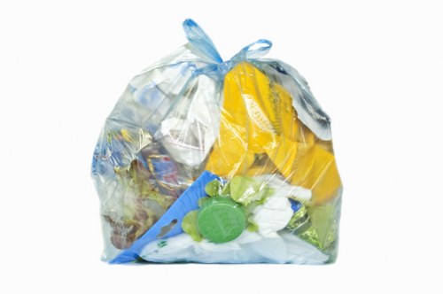 Skip hire truck departing site with load secured and safety cones in place