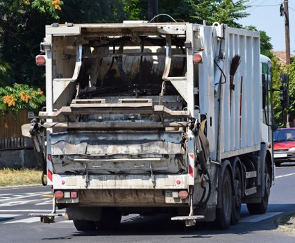 Team loading waste into a van in urban area